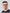 Porträtfoto des IT- und Technikverantwortlichen von BabyLions mit schwarzer Brille, kurzem dunklem Haar und schwarzem T-Shirt vor einfarbig grauem Hintergrund – professionelle Vorstellung im Teamprofil.