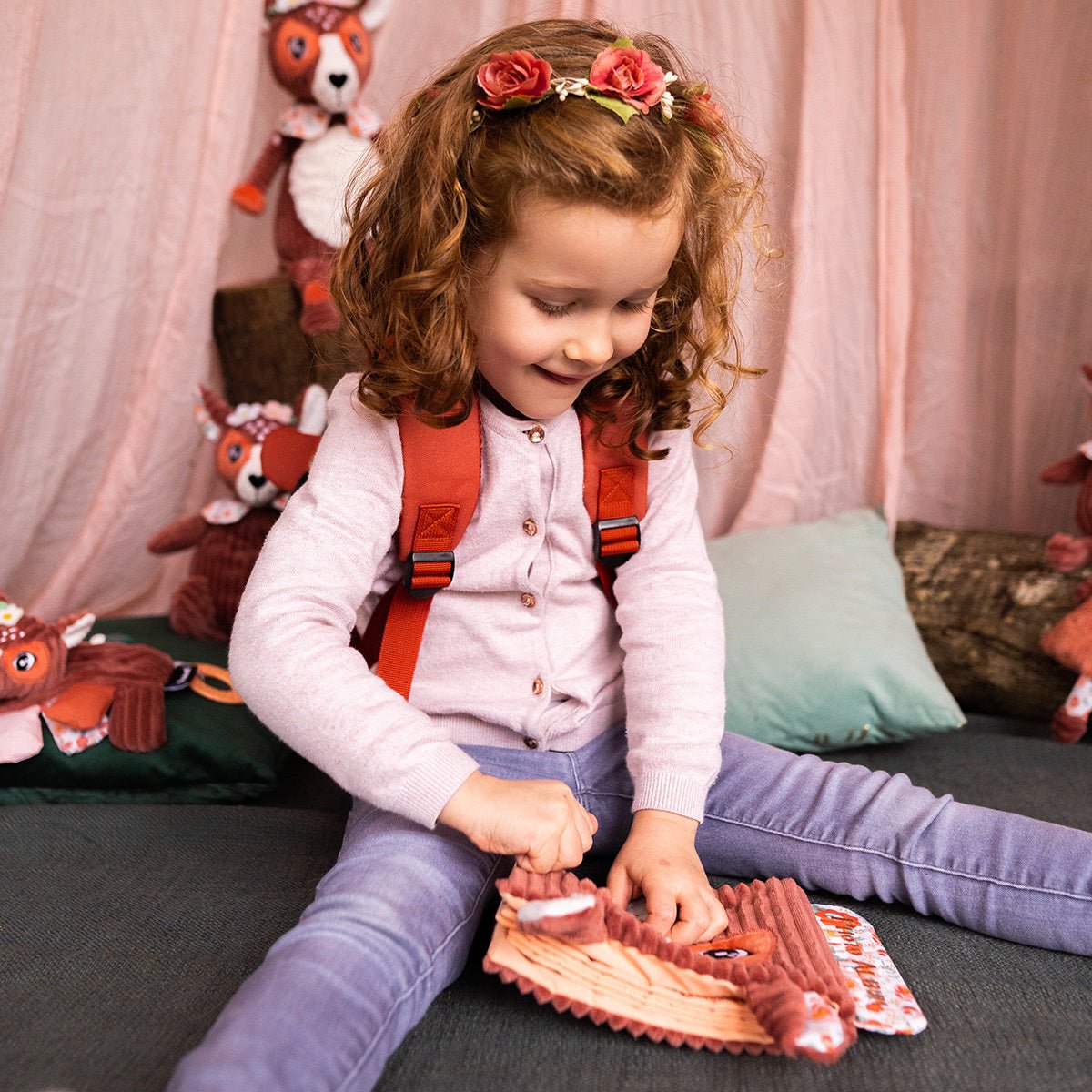 Kind spielt mit Baby Fotoalbum aus Plüsch Reh – 10 Fototaschen
