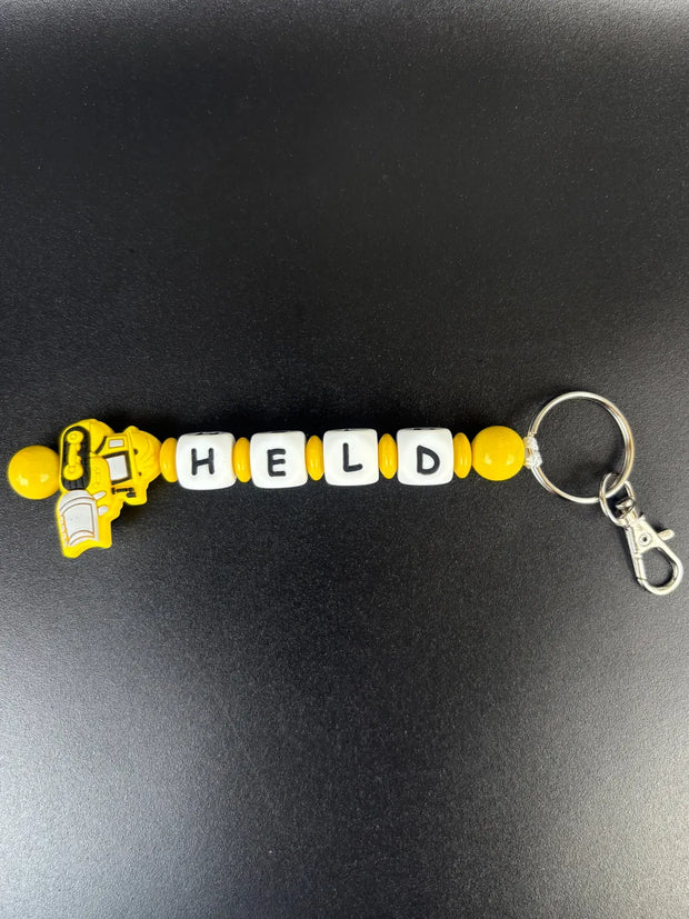 Personalisierter Schlüsselanhänger mit Namen und gelbem Bagger-Motiv – handgefertigter Schlüsselanhänger mit Buchstabenperlen von BabyLions®