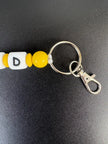 Personalisierter Bagger Schlüsselanhänger mit gelben Perlen, Buchstaben, Schlüsselring und Karabiner von BabyLions®