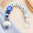 Personalisierte Schnullerkette mit Namen Elias und Nazar-Motiv in Blau und Weiß