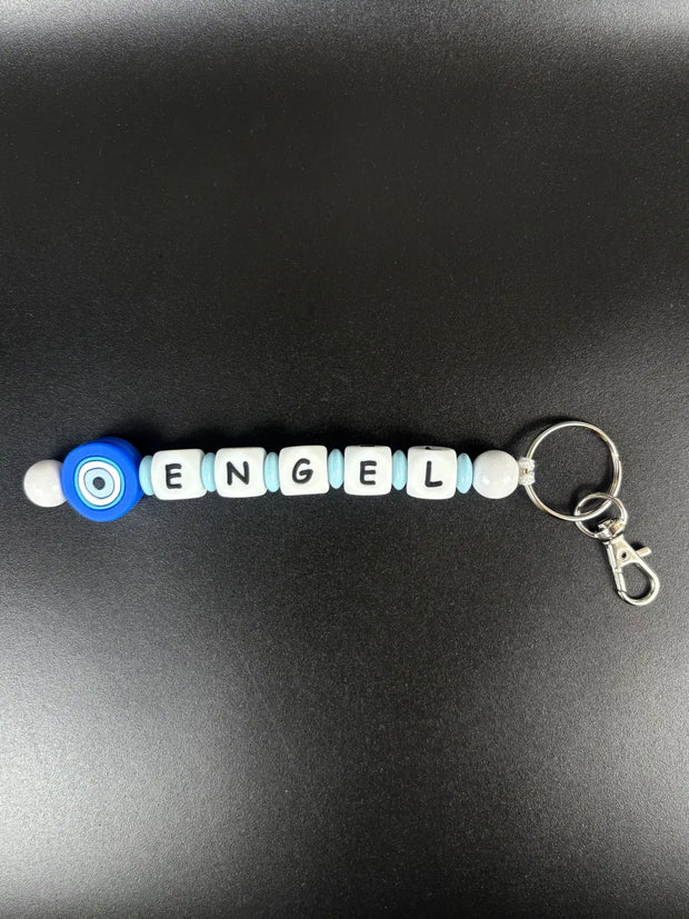 Personalisierter Schlüsselanhänger mit Namen Engel und blauem Nazar Auge – handgefertigtes Geschenk von BabyLions®